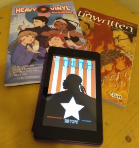 Image of comics Heavy Vinyl and The Unwritten, and Kindle showing the cover of Truth: Red, White, and Black.