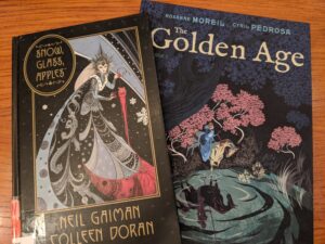 Photo of the covers of Snow, Glass, Apples by Neil Gaiman and Colleen Doran, and The Golden Age by Roxanne Moreil and Cyril Pedrosa.